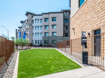 a yard in front of a building with a fence